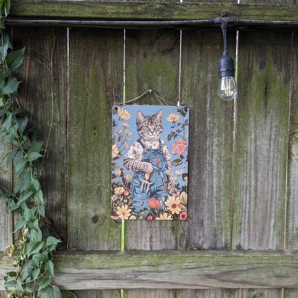 Male cat gardening, yellow red flowers blue metal tin garden sign